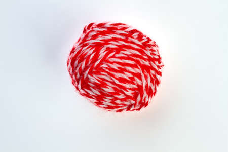 Ball of red yarn on white background. Ball of red and white yarn for knitting isolated on white background.の写真素材
