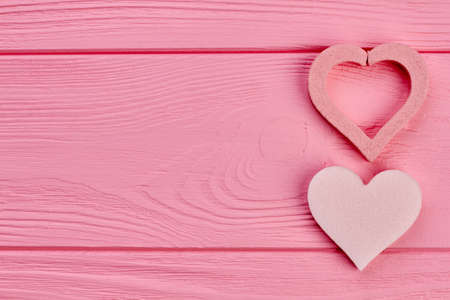 Hearts on pink wooden background, copy space. Two pink hearts on wooden plank, space text. Happy Valentines holiday.の写真素材