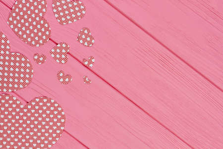 Paper hearts on pink wooden background. Hearts made from colorful paper with copy space, top view. Paper craft for Valentines holiday.の写真素材
