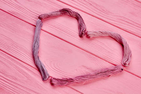 Heart shape from pink threads. Pink heart from colorful threads for embroidery with copy space. Threads art design.の写真素材