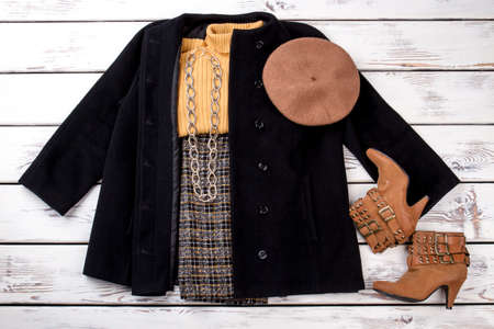 Trendy winter women outfit with hat and footwear. Clothes with chain necklace.の写真素材