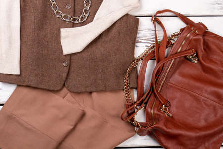 Set of fancy women clothes with red satchel. Fashionable red purse and garment, close up.の写真素材