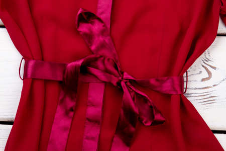 Red bow dress, close up. Silk knotted clothes.