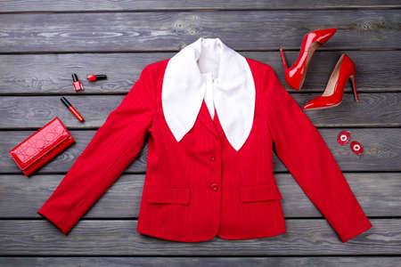 Red female blazer and accessories. Flat lay glamour red clothing, shoes and wallet.の写真素材