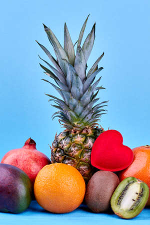 Mix of colorful exotic fruits. Assorted tropical fruits on blue background. Healthy organic food for gourmet.の写真素材