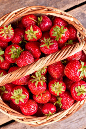 Fresh strawberries in basket, top view. Ripe fruits on farmer market. Healthy nutritious berries.の写真素材