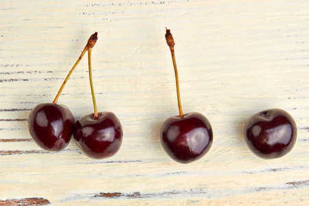 Delicious cherries on white wooden surface. Ripe juicy berries on vintage wood.