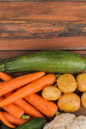 Different vegetables on wood. Top view.