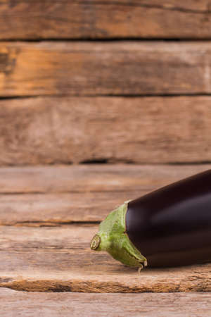 Raw eggplant on wooden table. Close up. Cropped image.の写真素材