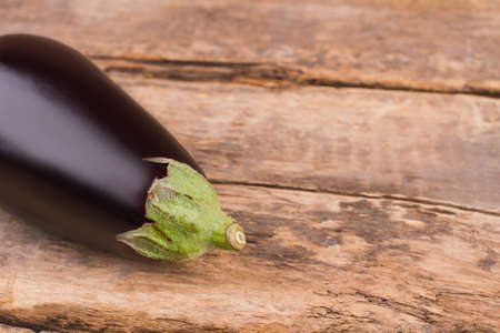 Organic eggplant on wood. Old vintage rustic table, free space for text. Close up.