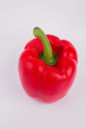 Paprika bell papper isolated on white background. Close up. One single shiny red pepper.の写真素材