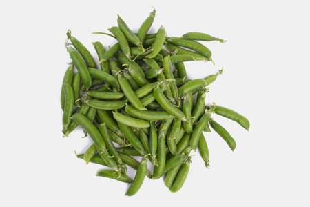 Pile of raw green organic snap peas. White isolated background.の写真素材