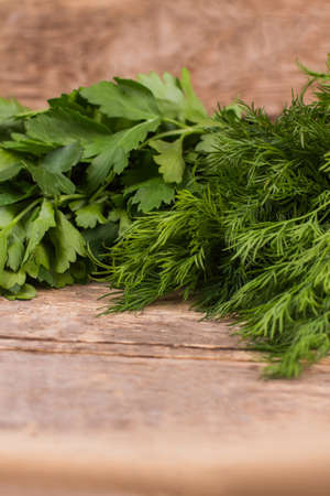 Fresh Parsley and Dill. Close up. Old rustic wooden table.の写真素材