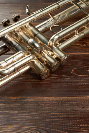 Detail of old trumpet instrument. Close up trumpet on wooden background with copy space. Classical...