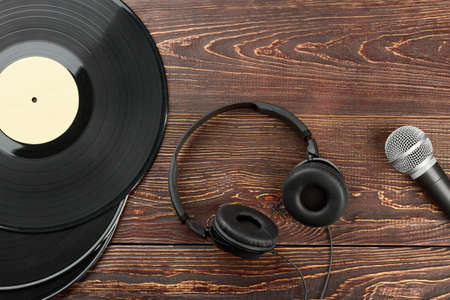 Headphones, vinyl records and microphone. Vinyl plates, headphones and microphone. Old and modern audio equipment.の写真素材