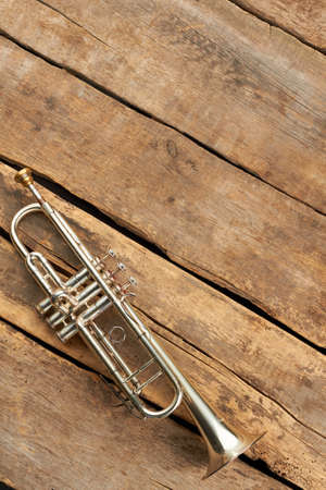 Classical trumpet and copy space. Old trumpet on rustic wooden boards, top view.