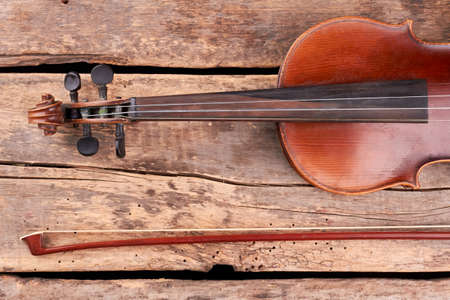 Violin and fiddle stick, cropped image. Part of vintage violin. Scroll and peg box. Classical...