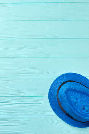 Blue woven hat with black ribbon. Summer hat on colored background and copy space. Headgear for summer rest.の写真素材