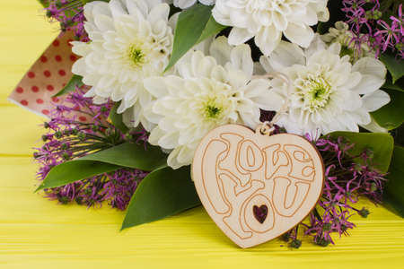 Colorful flowers and Valentines Day heart. Love and Valentines Day concept. Romantic holiday decor.の写真素材