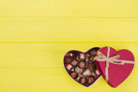 Gift box with dark and milk chocolate. Chocolate box in a shape of heart with copy space. Valentine holiday greeting card.の写真素材