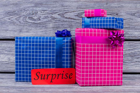 Colorful gift boxes on wooden background. Group of beautiful present boxes on vintage wood. Birthday surprise concept.の写真素材