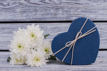 White flowers and blue heart-shaped box. Happy Valentines Day card. Give love and romance.の写真素材
