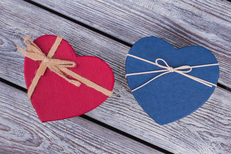 Beautiful heart shaped gift boxes. Two present boxes in heart shape on rustic background. Love and romance concept.の写真素材