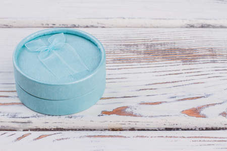 New design jewelry packing gift box. Blue jewelry gift box in a shape of tube, copy space. Fashion jewellery wrapping.の写真素材