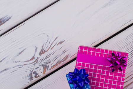 Christmas gift boxes with copy space. Festive gift boxes on vintage wooden background with space for...