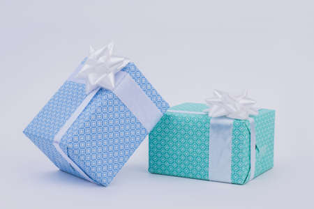 Gift boxes with bow on light background. Holiday background with beautifully packed present boxes.の写真素材
