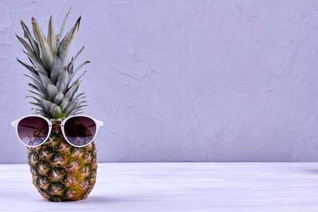 Pineapple wearing sunglasses and copy space.