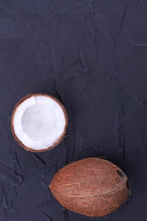 Ripe coconuts on black background, top view.の写真素材