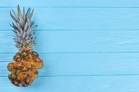 View from above on composition from cut pineapple fruit and copy space.の写真素材