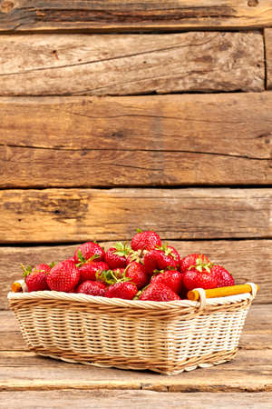 Ripe delicious strawberries in wicker basket.の写真素材