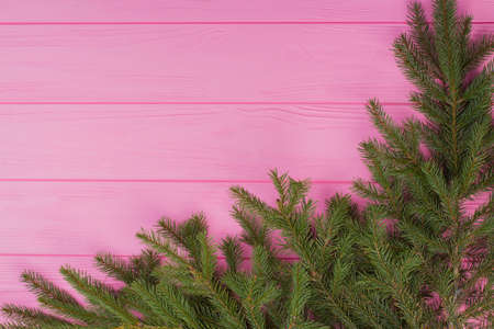 Christmas wooden background with fir branches. Decorative corner from conifer twigs with space for...