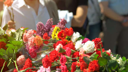 Victory Day flowers close up. Many fresh flowers in the memory of dead soldiers. Day of Glory.