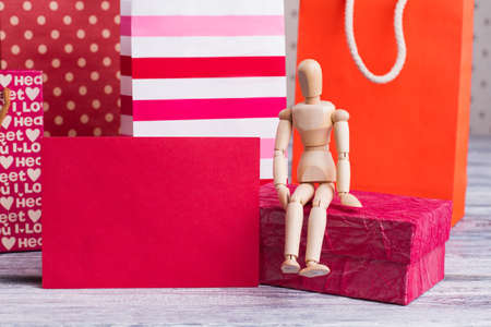 Shopping bags and blank paper card. Wooden dummy, gift box and card with copy space. Holiday...