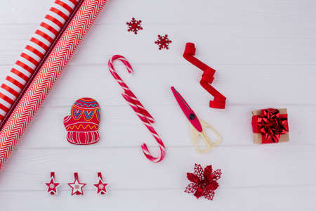Christmas present with decorations on wooden background. How to decorate Christmas gift at home.