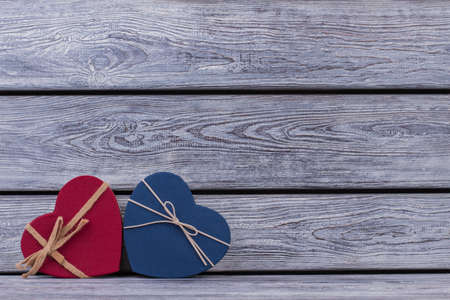 Red and blue heart-shaped goft boxes. Valentines Day background with colored boxes in a shape of...