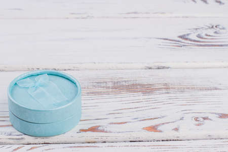 Round fabric box for jewelry. Floral pattern gift box for jewellery with copy space. Holiday present concept.の写真素材