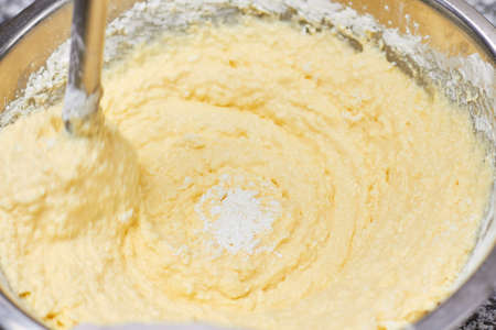 Mixing dough swirl, close up. Close up yellow dough in a bowl that is mixing.