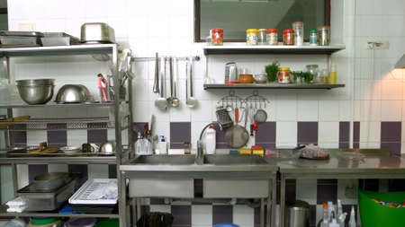 Various utensils at commercial kitchen. Cooking utensils on counter in commercial kitchen. Cooking...