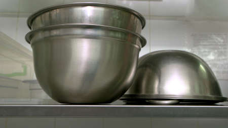 Stainless steel bowls at kitchen close up. Empty cooking utensils. Food cooking equipment.の写真素材