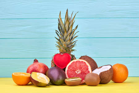 Fresh slices of ripe pineapple close up. Ripe exotic pineapple sliced into pieces on color background with copy space.の写真素材