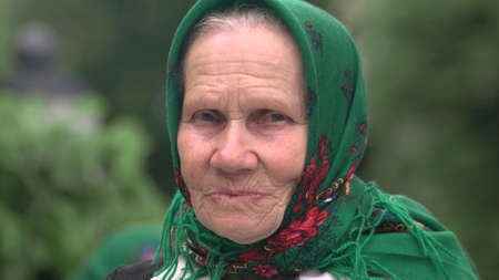 09.05.2018 - Kyiv, Ukraine. Portrait of lovely senior woman in kerchief. Image of old kind woman on...