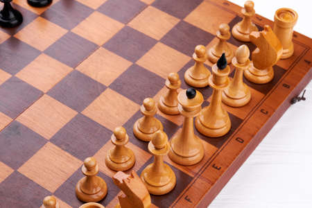 Chess board with chess pieces. Brown chess figures on chess board. Concept for competition, strategy...
