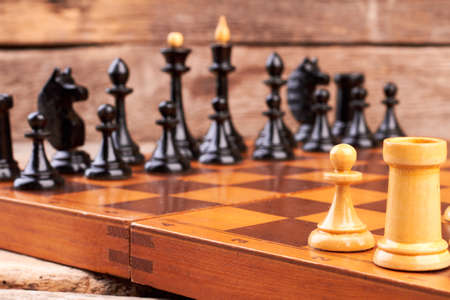 Chess board on table. Rook and pawn chess pieces. Chess game as intellectual leisure. Popular...