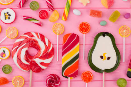 Composition with large sweet lollipops and candies. Dessert concept with lollipops, jellies and candies. Creative sweets layout.の写真素材
