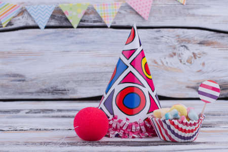Birthday accessories on wooden background. Party hat, colorful candies and other party items. Happy Birthday concept.の写真素材