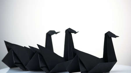 Three paper swans on white background. Composition of three origami birds. Amazing artistic work.の写真素材